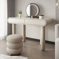 a white dressing table with a mirror and stool