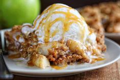 an apple pie on a plate with ice cream and caramel drizzled