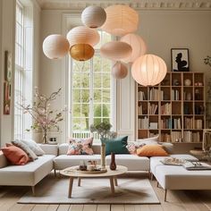 a living room filled with furniture and lots of lights hanging from it's ceiling