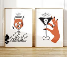 two framed art pieces with drinks on them, one is orange and the other is black