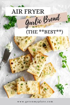 slices of garlic bread with parsley on the side and a buttered knife next to it