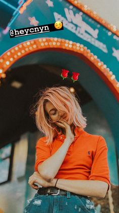 a woman standing in front of a neon sign