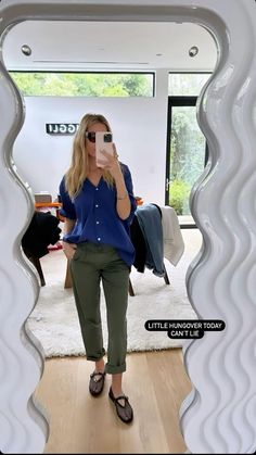 a woman taking a selfie in front of a mirror