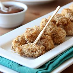 some food is on a white plate with chopsticks