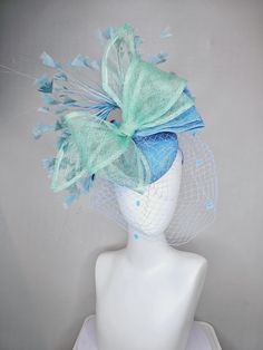 From the 2024 Featured Milliner of the Kentucky Derby Museum  Gorgeous Kentucky Derby hat fascinator  kentucky derby hat fascinator baby blue sinamay w/ mint green mesh wired ribbon large bow decor, teal blue branching feathers w/ mesh veil headband attachment each hat is totally one of a kind! no two are alike! I can probably add feathers, flowers etc to existing hats for a small fee. I cannot remove anything from existing hats. Just message me and see if we can make it work! :) I cannot make custom order from scratch. My schedule is unfortunately too crazy :( *All hats are sold as displayed. No returns do to nature of product (headwear) Of course do not hesitate to contact me with any issues :) Check out my The Hat Doctor amazing news story feature!! https://www.wdrb.com/derby_148/kentuc Veil Headband, Derby Hats Fascinators, Hat Fascinator, Kentucky Derby Hat, Bow Decor, Derby Hat, Large Bow, Wired Ribbon, Kentucky Derby