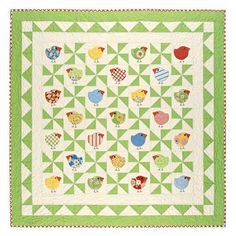 a green quilt with chickens on it and an orange frame around the edges that says,