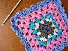 a crocheted doily is sitting on a table next to a knitting needle