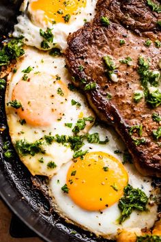 steak and eggs in a cast iron skillet with parsley on the side, ready to be eaten