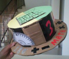 a cardboard hat with a calculator and clock on it, made to look like a construction site