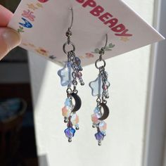 a pair of earrings is being held up