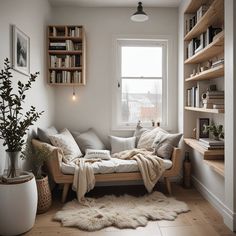 a living room filled with lots of furniture and bookshelves next to a window