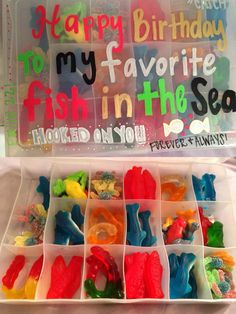 a plastic box filled with lots of gummy bears and some writing on the side