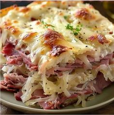 a close up of a plate of food with meat and cheese