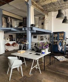 an industrial loft with tables and chairs in it