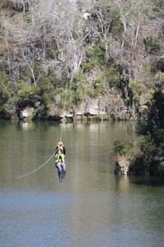 a person on a rope in the water