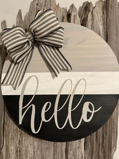 a wooden sign that says hello with a bow on it