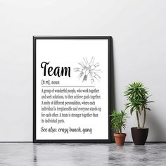 a black and white poster with the words team on it next to a potted plant