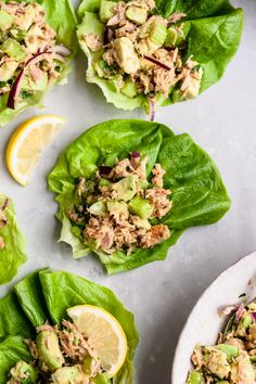 lettuce wraps filled with tuna salad and garnished with lemon wedges