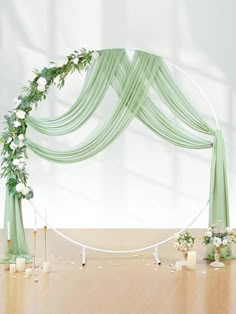 an arch decorated with flowers and greenery for a wedding ceremony is displayed on the floor