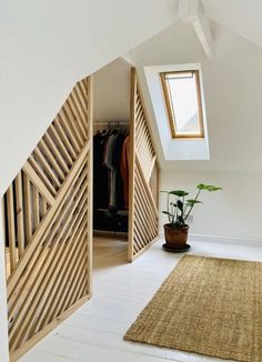 an open door leading to a bedroom with a plant in the corner and a potted plant next to it