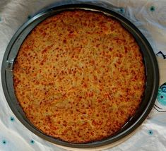 a pizza sitting on top of a pan covered in cheese