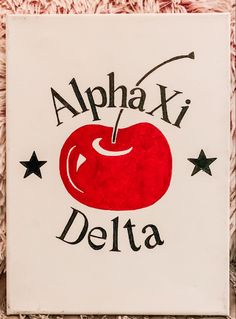 a sign that says,'alphabet delta'with an apple in the center and stars around it