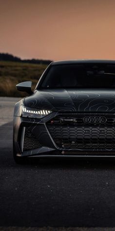 the front end of an audi car on a road