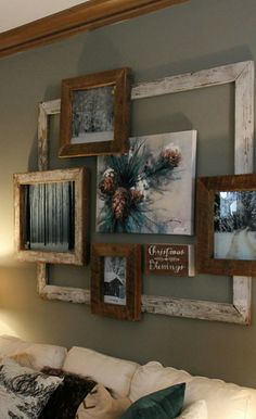 a living room filled with furniture and framed pictures on the wall above it's headboard