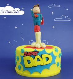 a birthday cake with the words super dad written on it and a cartoon figure standing on top