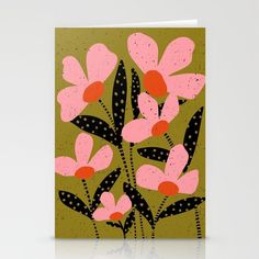 a card with pink and black flowers on green, polka doted paper in the background