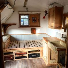 an empty kitchen with wooden cabinets and drawers