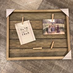 an old wooden frame with two pictures hanging on it and clothes pins attached to them