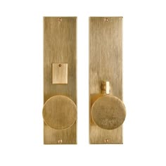 two brass door handles on white background