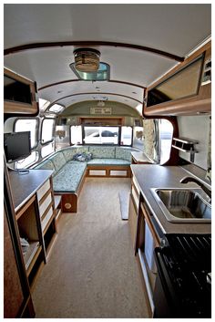 the interior of an rv with kitchen and living area