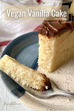 a slice of vegan vanilla cake on a blue plate with a fork next to it