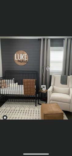 a living room filled with furniture and a baby crib in front of a window