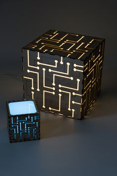 an illuminated cube next to a small square box