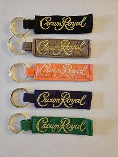 four keychains with the words crown royal and crown royal written on each one