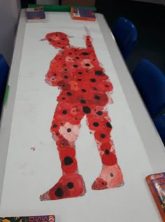 a child's drawing of a man in red and black dots