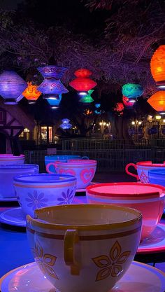 cups and saucers lit up with colorful lights