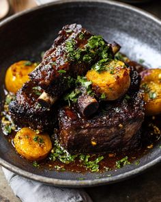 steak with potatoes and parsley in a bowl