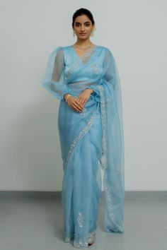 Powder blue silk organza saree with zardosi hand embroidered borders. Comes with a blouse.
Components: 2
Pattern: Hand embroidered
Type Of Work: Zardosi
Neckline: V Neck
Sleeve Type: Puffed Sleeves
Fabric: Silk organza
Color: Blue
Other Details: 
Disclaimer : The product will dispose off some color, since it is hand dyed.
Occasion: Wedding - Aza Fashions Luxury Blue Pre-draped Saree With Dori Work, Luxury Organza Pre-draped Saree With Dori Work, Luxury Dori Work Saree, Ceremonial Saree With Dori Work, Luxury Blue Saree With Unstitched Blouse, Luxury Blue Organza Saree, Luxury Saree With Dori Work For Festive Occasions, Cheap Dori Work Saree For Puja, Luxury Unstitched Saree With Dori Work