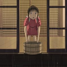 a girl standing on top of a barrel in the rain