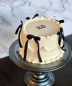 a white cake with black bows on top