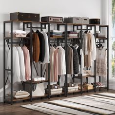 an organized closet with clothes and suitcases hanging on the rack, in front of a window