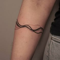 a man's arm with a tattoo on it that looks like a wavy wave