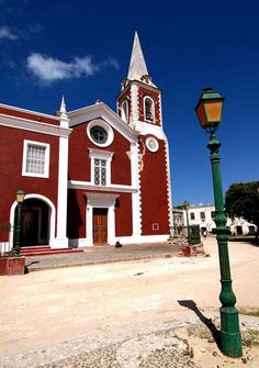 an old red church with a green street light