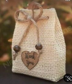 a small bag with a wooden heart on it and the words thank you written on it