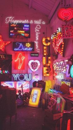 many neon signs are hanging from the ceiling