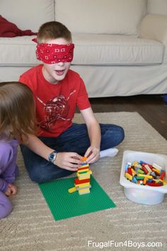 two children playing with legos on the floor